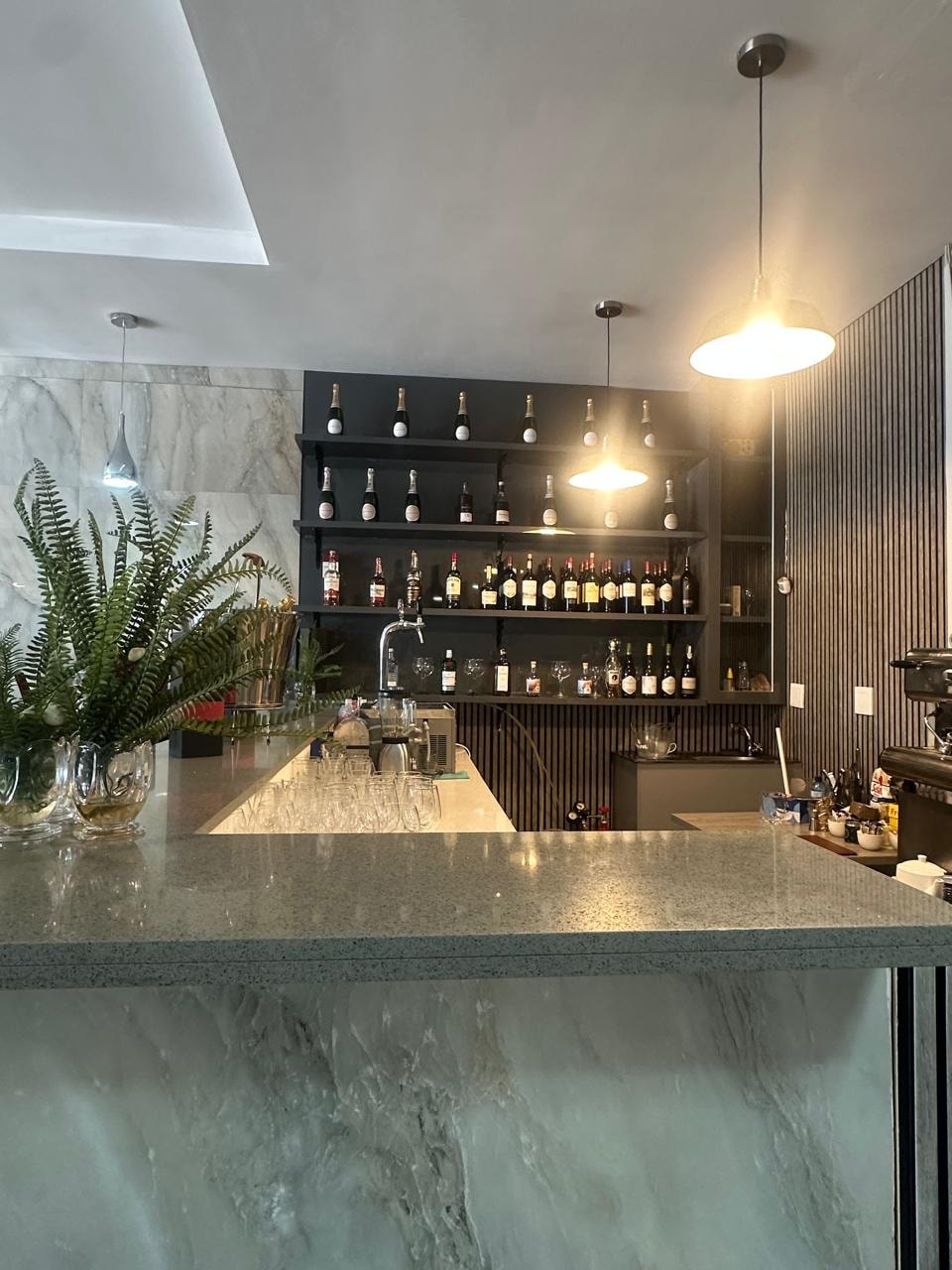 The bar at SAB'OR with backlit wine shelves